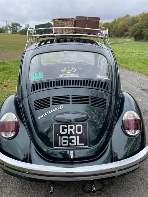 Full back view of VW Super Beetle with basket on top