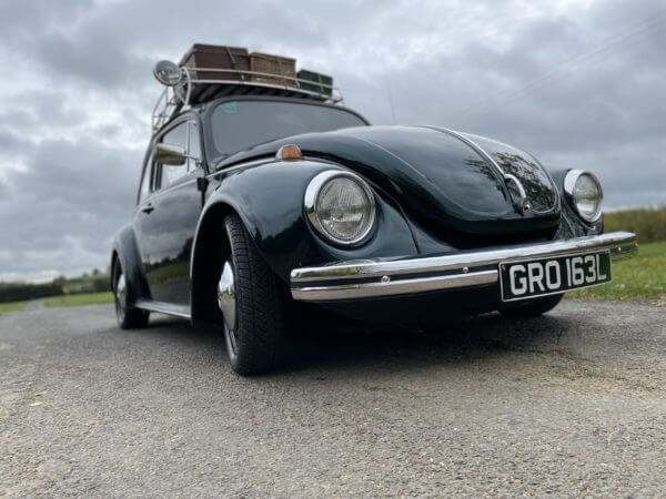 Low angle front corner of metallic green VW Super Beetle