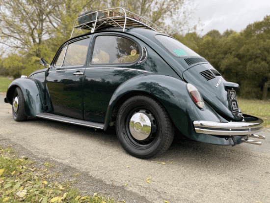 Side view of metallic green VW Super Beetle