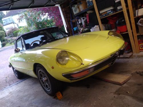 Yellow Alfa Romeo Spider Veloce in garage