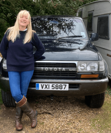 Heritage customer Catherine White standing in front of her green Toyota Land Cruiser