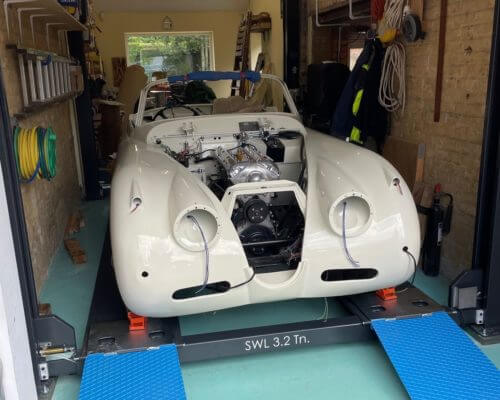 white Jaguar XK 150S in garage