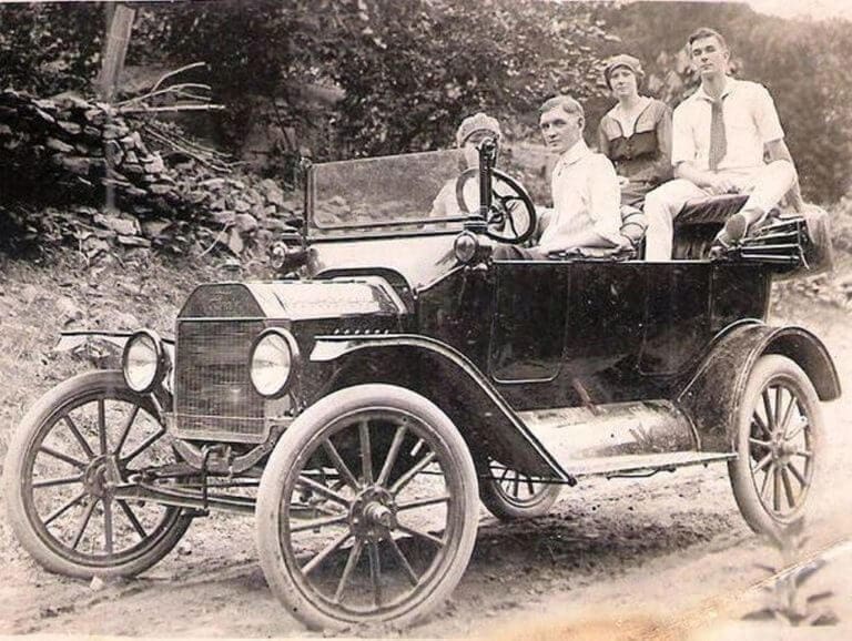 Four young people aboard a 1916 Ford Model T touring car