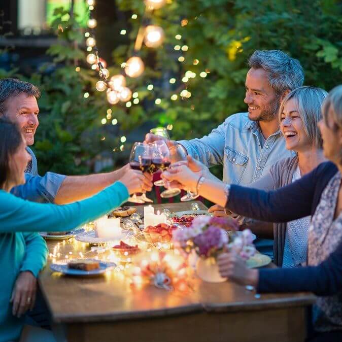 happy friends enjoying dinner in the garden - Norton Insurance personal client manager service - for everything that matters most to you